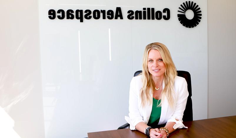 Collins Aerospace employee Crystal Loftsgard sitting at her desk